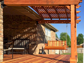 B Grade redwood decking and a beautiful, curved railing with built-in bench makes a perfect outdoor space.